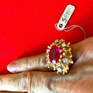 Man made ruby ring surrounded by real diamonds.